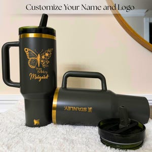 Gold laser engraved Stanley style 40oz tumbler featuring a personalized name, designed as a unique birthday gift for women. Includes a flip straw lid and sturdy handle for convenience and daily use. This insulated tumbler keeps beverages hot or cold for extended periods and offers a stylish and modern look, making it a thoughtful and practical personalized gift.