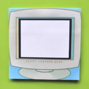May include: A blue and white computer monitor notepad with the text "Dizzy Leopard Shop" printed on the bottom. The monitor has a white frame and a black screen.