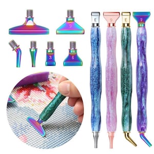 May include: A set of four diamond painting pens with marbled, glittery resin handles in blue, pink, green, and purple, accompanied by six interchangeable metal tips in a rainbow finish, including various flat and angled applicator shapes.