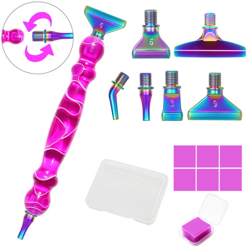 May include: A pink and white diamond painting pen with interchangeable iridescent tips. Includes a clear plastic case, pink wax squares, and a small container of pink wax. The tips are labeled with numbers.