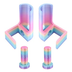 May include: Two L-shaped brackets with a rainbow gradient finish, each featuring a vertical cylindrical section and a horizontal base with a threaded hole. Two matching rainbow-colored threaded bolts are positioned below the brackets.