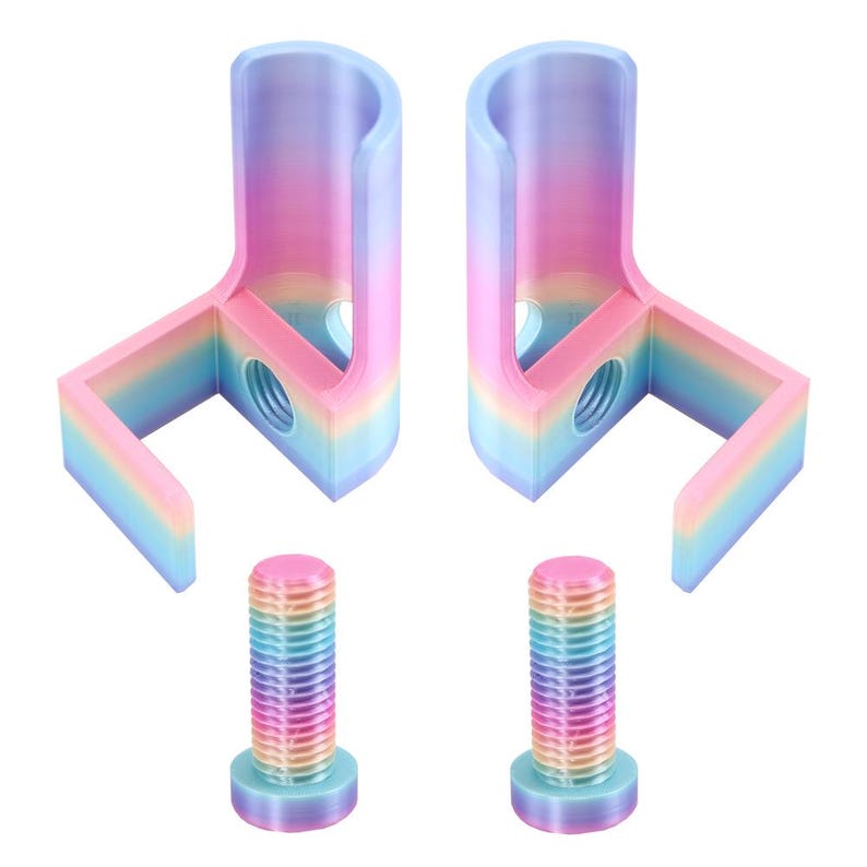 May include: Two L-shaped brackets with a rainbow gradient finish, each featuring a vertical cylindrical section and a horizontal base with a threaded hole. Two matching rainbow-colored threaded bolts are positioned below the brackets.