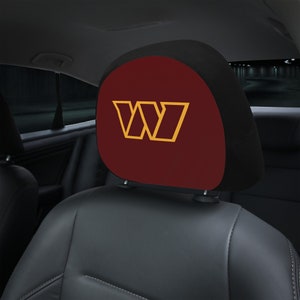 May include: Burgundy car seat headrest with a gold "W" logo.