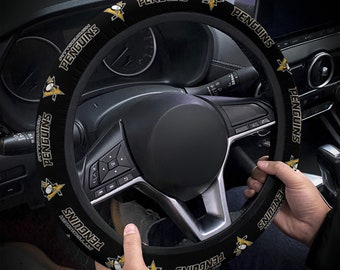 May include: Black steering wheel cover with the Pittsburgh Penguins logo and team name repeated around the cover.