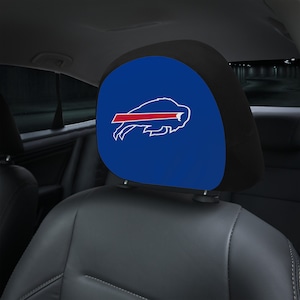 May include: Blue and black car seat headrest cover with the Buffalo Bills logo. The logo is a white buffalo with a red stripe across its body.