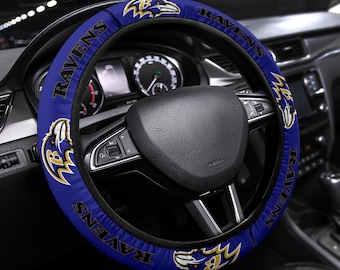 May include: A blue steering wheel cover with the Baltimore Ravens logo and the word "Ravens" repeated around the edge.