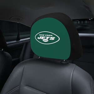 Puede incluir: Reposacabezas de asiento de coche verde y negro con el logotipo de los New York Jets en blanco.