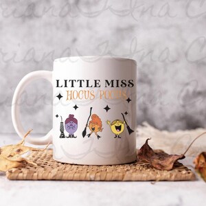May include: White ceramic mug with a black and white design featuring the text "Little Miss Hocus Pocus" and three cartoon characters.
