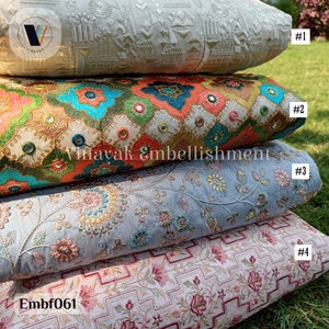 May include: Four different fabric swatches with embroidered designs. The top swatch is white with a raised pattern. The second swatch is orange, green, and blue with a geometric pattern and mirror embellishments. The third swatch is light blue with a floral pattern. The bottom swatch is pink with a geometric pattern and floral accents. The swatches are labeled #1, #2, #3, and #4. The text "Embf061" is visible in the bottom left corner.