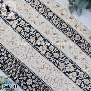 May include: Five different trims of black and white embroidered fabric with gold accents. The trims feature floral designs and geometric patterns.