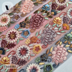 May include: A close-up of a delicate floral embroidery on a sheer fabric. The embroidery features a variety of colorful flowers, including pink, red, yellow, and blue. The fabric is a light, airy mesh, and the embroidery is intricate and detailed. The text "Emb1361" is visible in the bottom left corner of the image.