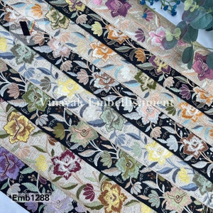 May include: Assortment of embroidered trim with floral designs in various colors, including black, gold, silver, and red. The trim is on a beige background. The text "Emb1288" is visible in the lower left corner of the image.