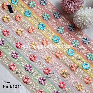 May include: A variety pack of 3 cm wide embroidered trim featuring floral designs in various colors, including gray, green, blue, orange, yellow, pink, purple, red, and white. The trim is made of sheer fabric with a delicate floral pattern. The text "Emb1014" is visible in the bottom left corner of the image.