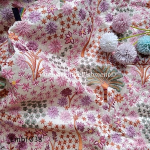 May include: A white fabric with a floral embroidery pattern in shades of pink, green, and orange. The fabric has a textured surface and a subtle sheen. The text "Embf038" is visible in the bottom left corner of the image.