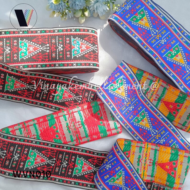 May include: Assortment of colorful patterned trim with geometric designs in red, green, blue, yellow, and white. The trim is woven with a variety of textures and patterns. The trim is labeled "WVN010".