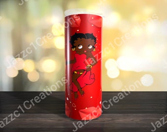 May include: A cylindrical tumbler with a vibrant red background featuring a cartoon character with black hair, gold hoop earrings, and a red dress. The design includes scattered white heart shapes and red petal-like accents across the surface.