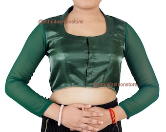May include: A dark green blouse with a square neckline and sheer long sleeves. The blouse has a satin-like finish and a small opening down the front. The sleeves are a darker shade of green. The blouse is a stylish top.