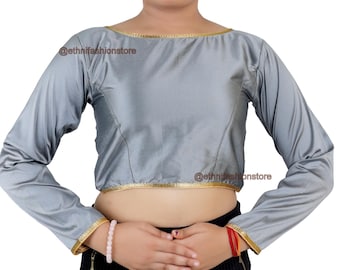May include: A gray, long-sleeved blouse with a boat neck and gold trim around the neckline and sleeves. The blouse is cropped and has a fitted silhouette.