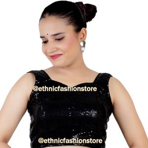 May include: A black sequined crop top with a square neckline and sleeveless design. The top features the text "@ethnicfashionstore" on the front.