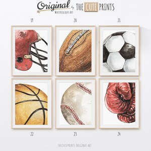 May include: Watercolor art prints of sports equipment, including a football helmet, football, soccer ball, basketball, baseball, and boxing glove. The prints are in wooden frames and feature the text "Original by THE CUTE PRINTS WATERCOLOUR ART".