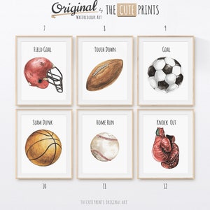 May include: Watercolor art prints featuring sports equipment. Includes a red football helmet, a brown football, a black and white soccer ball, a basketball, a baseball, and a red boxing glove. Each print has a sports-related word.