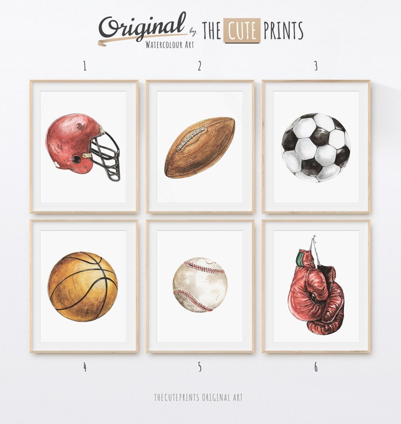 May include: Watercolor art prints featuring sports equipment: a red football helmet, a brown football, a black and white soccer ball, a basketball, a baseball, and a red boxing glove. The prints are framed and labeled "Original by THE CUTE PRINTS."