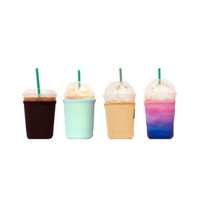 May include: Four iced coffee drinks in clear plastic cups with lids and straws. Each cup has a different colored sleeve: brown, light blue, beige, and ombre pink and blue.