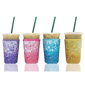 May include: Four insulated cup sleeves with a glitter design. The sleeves are in purple, pink, blue, and gold. Each sleeve has a clear plastic cup with a straw inside.