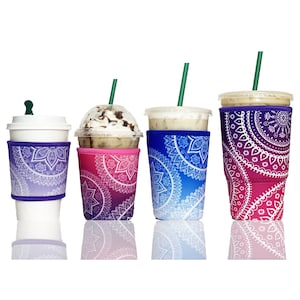 May include: Four reusable coffee cup sleeves in shades of purple, pink, and blue, each adorned with a white mandala design. The cups are filled with iced coffee and topped with lids and straws. The sleeves are designed to fit various cup sizes.