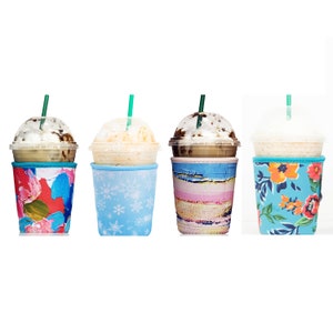 May include: Four different reusable coffee cup sleeves. The sleeves are made of neoprene and have various colorful patterns. The sleeves are designed to fit standard-sized coffee cups.