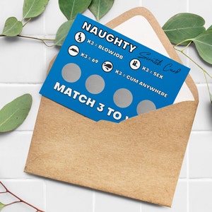 May include: A blue "Naughty Scratch Card" with silver scratch-off circles, text, and illustrations, inside a brown envelope. The card's text includes "X3 = BLOWJOB", "X3 = 69", "X3 = SEX", and "X3 = CUM ANYWHERE".