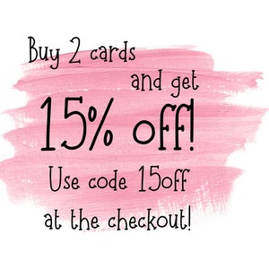 May include: Pink brushstroke background with black text. The text reads "Buy 2 cards and get 15% off! Use code 15off at the checkout!"
