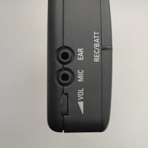 May include: Black cassette player with a volume knob, microphone and ear jack inputs, and REC/BATT label.