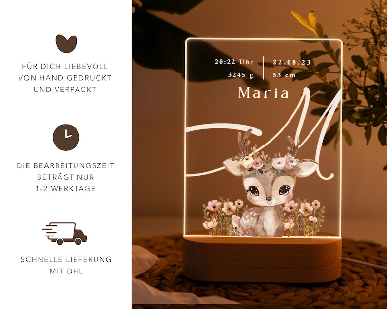May include: A white acrylic night light with a deer illustration and the text "Maria" and "20:22 Uhr 22.08.23 3245 g 53 cm". The night light has a wooden base.
