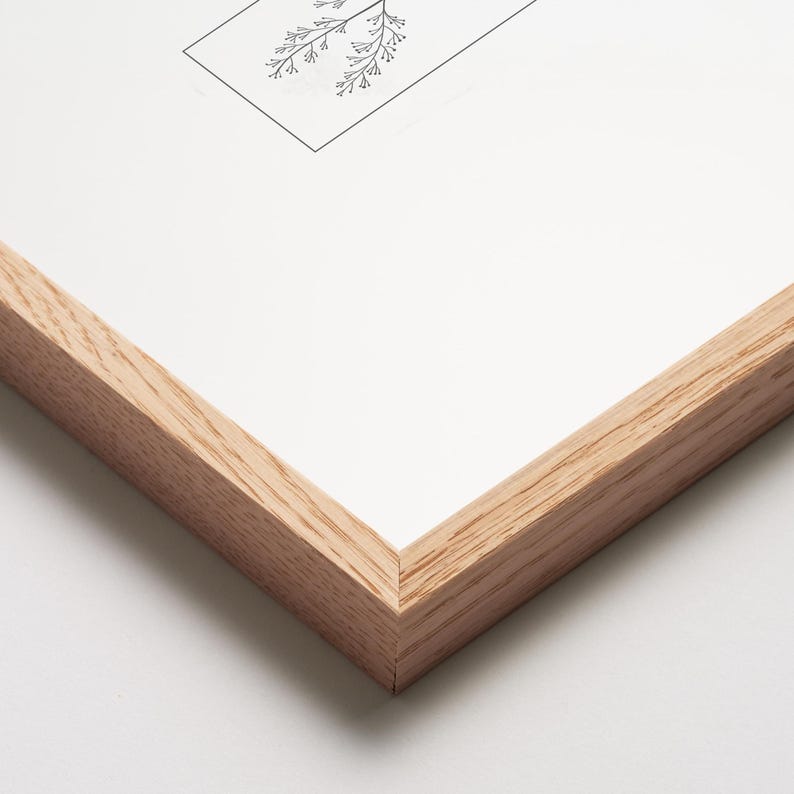 May include: A framed botanical print featuring a detailed black and white illustration of delicate plant sprigs. The artwork is set within a natural wood frame, showcasing the print's clean lines and minimalist aesthetic. The frame's light wood tone complements the artwork.