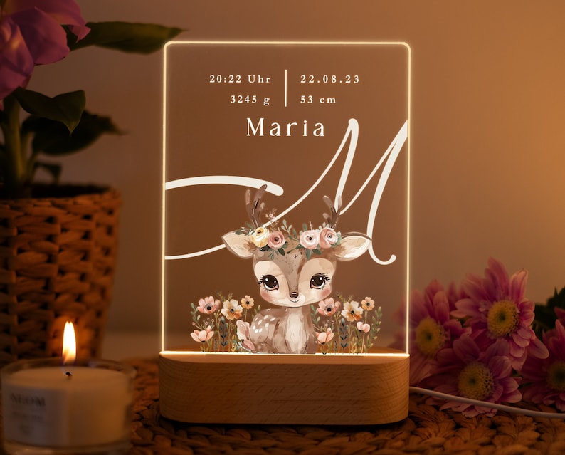 May include: A white acrylic night light with a deer illustration and the name Maria. The light also displays the date 22.08.23, time 20:22 Uhr, weight 3245 g, and height 53 cm.