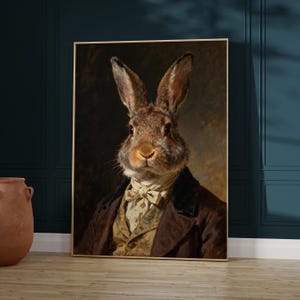 May include: A framed portrait depicting a rabbit in period clothing. The rabbit has brown fur, a white cravat, and a brown coat. The artwork is set against a dark backdrop, creating a classic and whimsical aesthetic, reminiscent of historical portraiture.