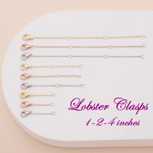May include: A set of eight gold, rose gold, and silver lobster clasps in various lengths, ranging from 1 to 4 inches. The clasps are displayed on a white surface.