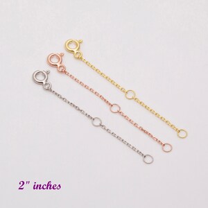 May include: Three gold chain extenders, each 2 inches long, in gold, rose gold, and silver.