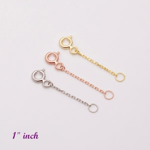 May include: Three gold chain extenders, one in yellow gold, one in rose gold, and one in silver, each measuring 1 inch in length.