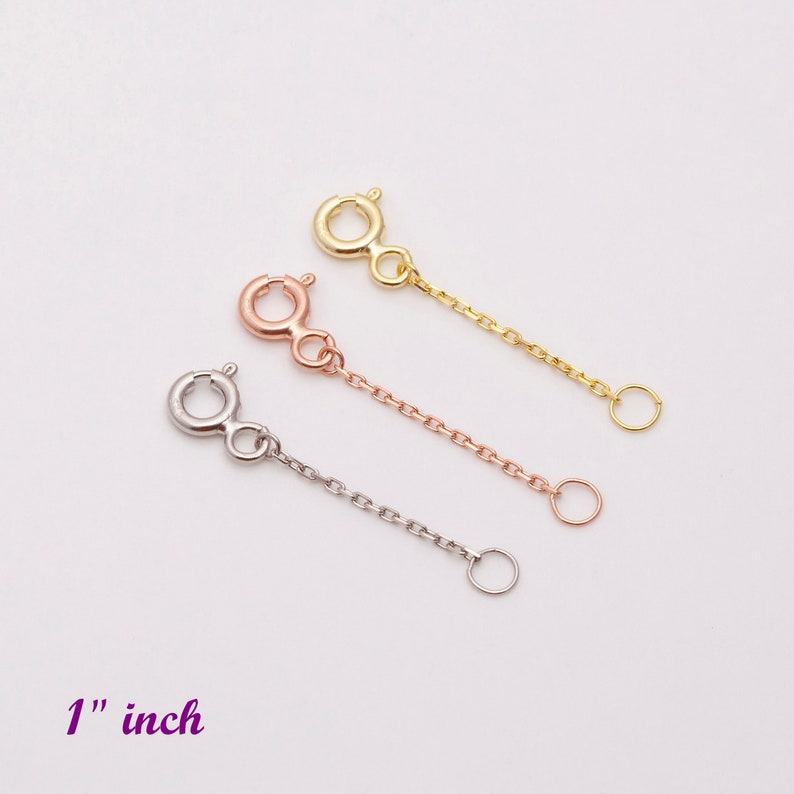 May include: Three gold chain extenders, one in yellow gold, one in rose gold, and one in silver, each measuring 1 inch in length.