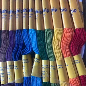 May include: A set of 12 embroidery floss spools in rainbow colors, labeled "ship" and "Made in China". Each spool contains 8 meters of cotton floss.