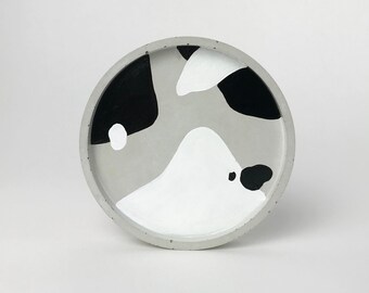 Round concrete trinket dish with black and white abstract pattern