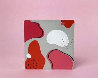 Square concrete coaster, with multicoloured hand painted abstract pattern