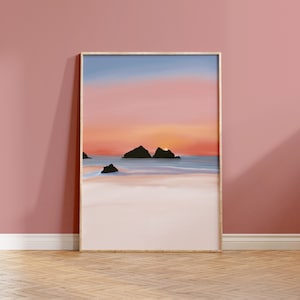 May include: A framed print of a digital painting depicting a seascape with two rocky islands in the foreground and a sunset in the background. The sky is a gradient of pink, orange, and blue. The water is a light blue and the sand is white.