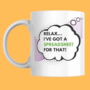 May include: White ceramic mug with a curved handle. The mug features the text "RELAX... I'VE GOT A SPREADSHEET FOR THAT!" in a speech bubble design with black, green, and purple accents. The background is a solid orange.