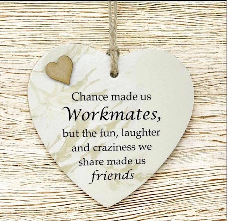 Puede incluir: Placa de madera en forma de coraz&oacute;n con el texto "Chance made us Workmates, but the fun, laughter and craziness we share made us friends". Un peque&ntilde;o coraz&oacute;n de madera est&aacute; adherido en la parte superior izquierda. La placa cuelga de un hilo natural.
