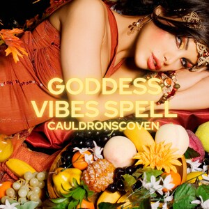 May include: A woman with long dark hair lays on a bed of fruit and flowers. The text "Goddess Vibes Spell" is written in yellow letters on the image. The text "CauldronScoven" is written in white letters below the first text.