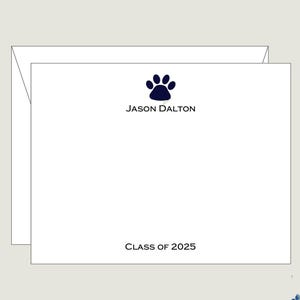 May include: White stationery set with a navy blue paw print and the name "JASON DALTON" printed above "CLASS OF 2025". The set includes a matching envelope.