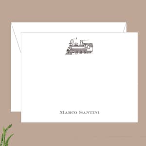 May include: A white card with a black and white illustration of a vintage steam locomotive. The card has the name "MARCO SANTINI" printed in black at the bottom.